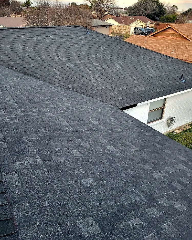 Architectural shingles meeting in a clean roof valley