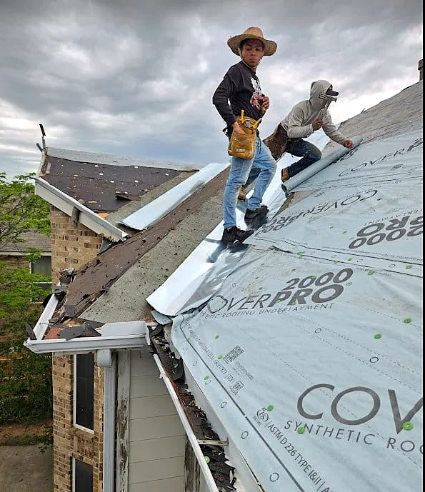 Nexgen crew members installing synthetic roof underlayment