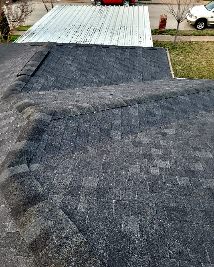 New shingle roof tying into a metal patio cover